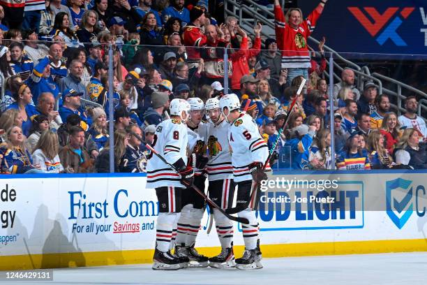 Sam Lafferty of the Chicago Blackhawks is congratulated after scoring a goal against the St. Louis Blues at the Enterprise Center on January 21, 2023...