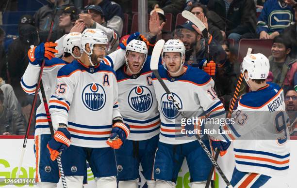 Connor McDavid of the Edmonton Oilers celebrates with teammates Darnell Nurse, Zach Hyman and Ryan Nugent-Hopkins after scoring a goal against the...