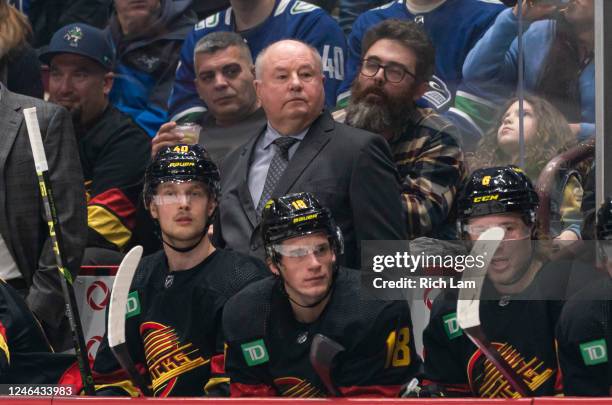 Bruce Boudreau, head coach of the Vancouver Canucks watches his team play against the Edmonton Oilers during the first period in NHL action on...