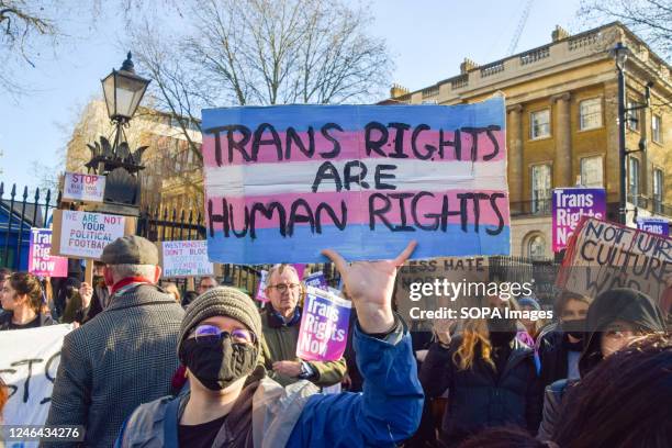Protester holds a placard which states 'Trans rights are human rights' during the demonstration. Protesters gathered outside Downing Street in...