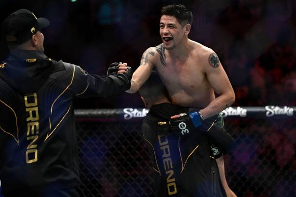 Mexican Brandon Moreno celebrates after defeating Brazilian Deiveson Figueiredo during their flyweight title bout at the Ultimate Fighting...