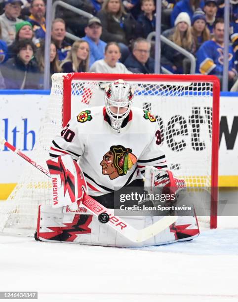 Chicago goaltender Jaxson Stauber blocks a shot on goal during a NHL game between the Chicago Blackhawks and the St. Louis Blues on January 21 at...