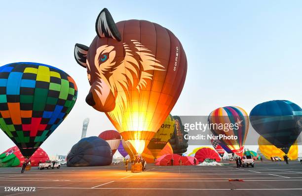 Crew members prepare their hot air balloon during the Qatar balloon festival 2023 near Khalifa International Stadium in Doha ,Qatar on 22 January...