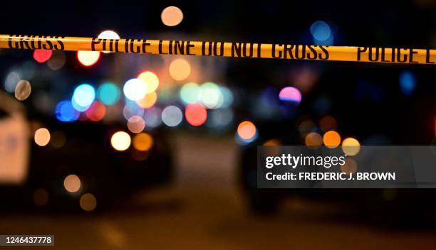 Police tape is pictured at the scene near the intersection of Garvey and Garfield Avenue in Monterey Park, California, on January 22 where police are...