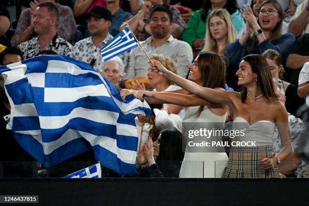 Fans hold Greece's national flag as Italy's Jannik Sinner plays against Greece's Stefanos Tsitsipas during their men's singles match on day seven of...