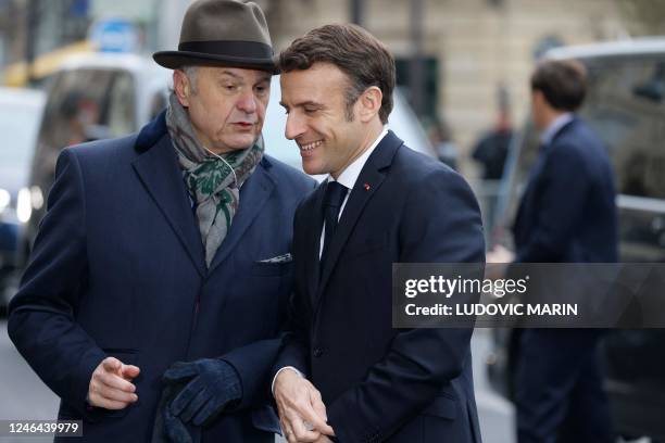 France's President Emmanuel Macron listens to presidential Elysee Palace chief of protocol Philippe Franc as he arrives to attend a ceremony as part...