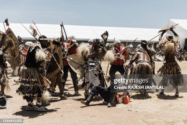 Group in British uniforms is assailed by Zulu warriors during the reenactment of the Battle of Isandlwana, in Isandlwana on January 21, 2023. - The...