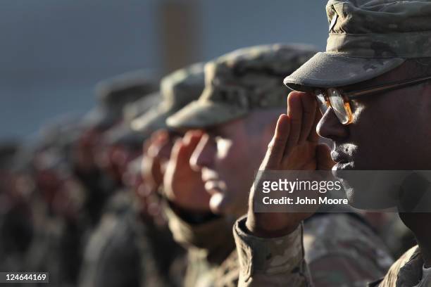Army soldiers salute during the national anthem during the an anniversary ceremony of the terrorist attacks on September 11, 2001 on September 11,...