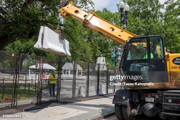 Workers build a metal fence reinforced with concrete block on 15th Avenue near the White House on June 05, 2020 in Washington, DC. After seven days...