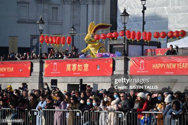 Giant figure depicting a rabbit is pictured among members of the public during the parade celebrating the Chinese Lunar New Year of the Rabbit, in...