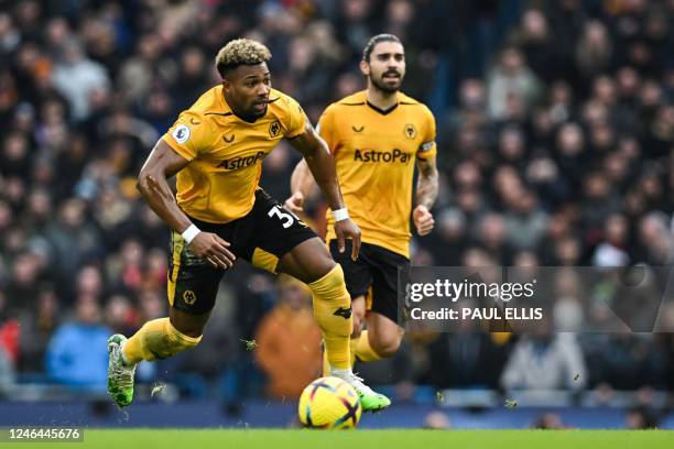 Wolverhampton Wanderers' Spanish midfielder Adama Traore runs with the ball during the English Premier League football match between Manchester City...
