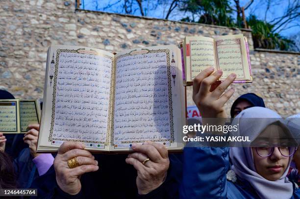 Protesters hold copies of the Koran in front of the Consulate General of Sweden in Istanbul on January 22 after Rasmus Paludan, leader of Danish...