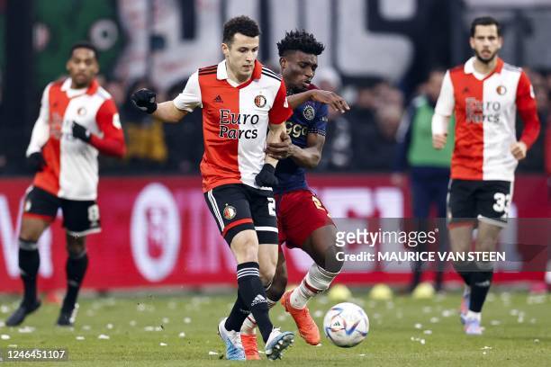 Feyenoord's Moroccan forward Oussama Idrissi fights for the ball with Ajax's Ghanaian midfielder Mohammed Kudus during the Dutch Eredivisie football...