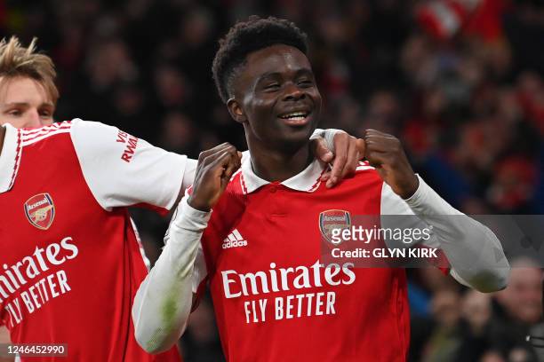 Arsenal's English midfielder Bukayo Saka celebrates after scoring their second goal during the English Premier League football match between Arsenal...