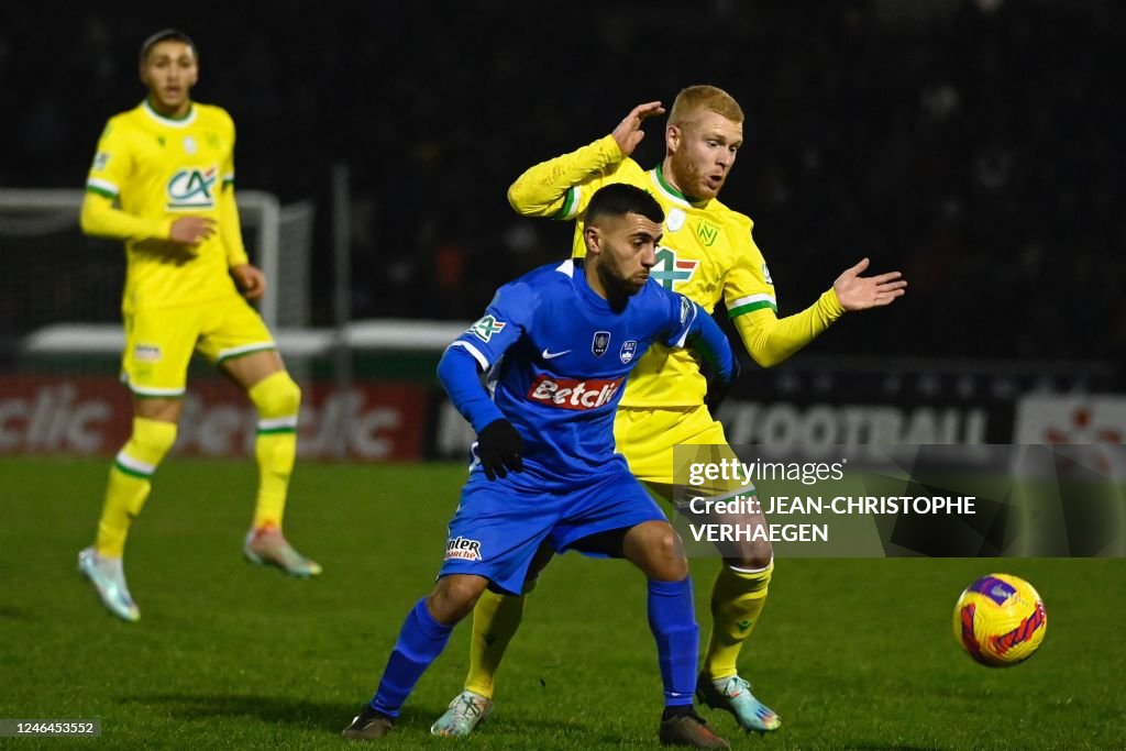 Thaon's French Algerian midfielder Karim Koriche fights for the ball