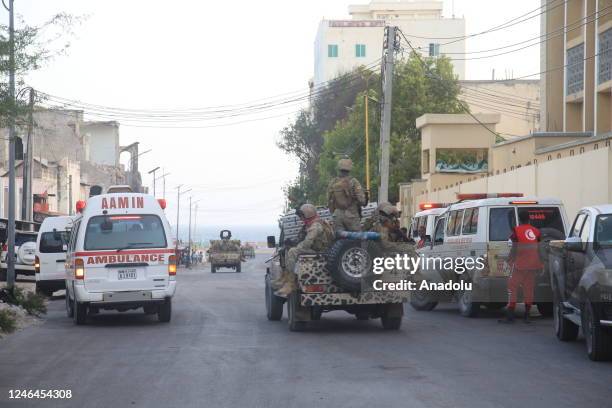Ambulances arrive at the scene after bombings followed by gunfire in Somalia's capital targeted the Banadir Regional Administration headquarters on...