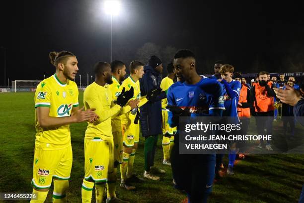 Nantes' players congratulate Thaon's players after the French Cup round of 32 football match between Entente Sportive de Thaon and FC Nantes at Stade...