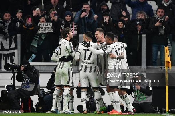 Juventus' Polish forward Arkadiusz Milik celebrates with teammates after scoring his team's second goal during the Italian Serie A football match...