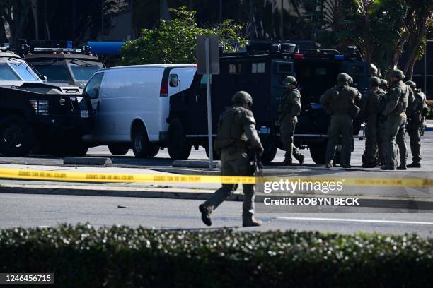 Law enforcement personnel are seen outside the site in Torrance, California, where the alleged suspect in the mass shooting in which 10 people were...