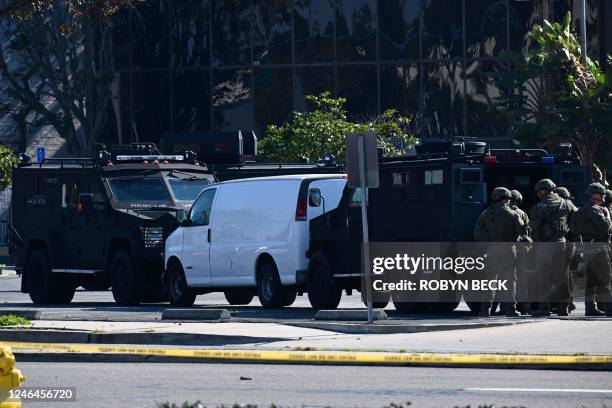 Law enforcement personnel are seen outside the site in Torrance, California, where the alleged suspect in the mass shooting in which 10 people were...