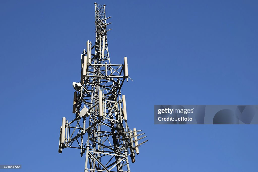 Phone mast against blue sky