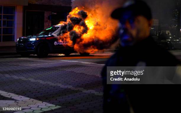 Firefighters work to extinguish a fire after an Atlanta police vehicle was set on fire during a "Stop cop city" protest in Atlanta, Georgia, United...
