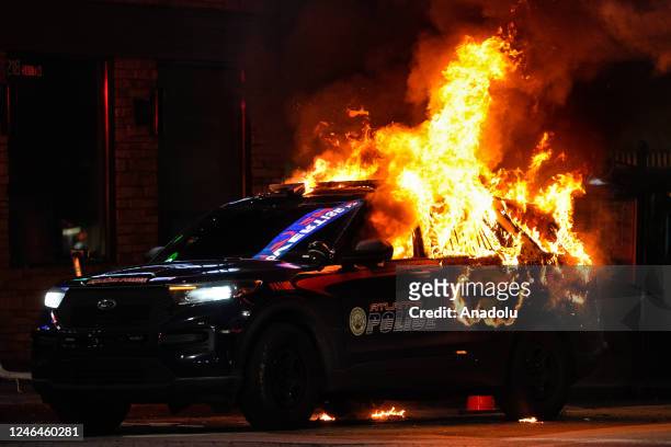 An Atlanta police vehicle is set on fire during a "Stop cop city" protest in Atlanta, Georgia, United States on January 21, 2023. Multiple buildings...