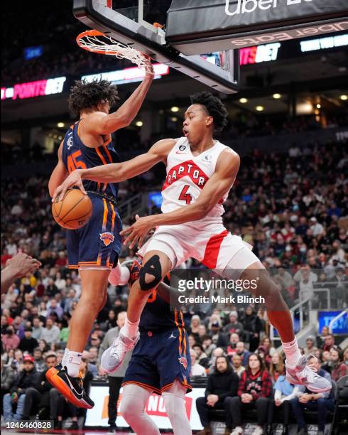 Scottie Barnes of the Toronto Raptors passes the ball against Jericho Sims of the New York Knicks during the second half of their basketball game at...