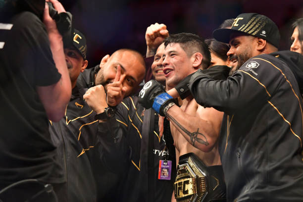 Brandon Moreno celebrates his victory over Deiveson Figueiredo in their Flyweight title fight during the UFC 283 event at Jeunesse Arena on January...