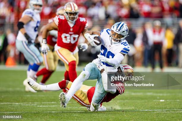 Dallas Cowboys running back Tony Pollard is tackled and twists his ankle during the NFL NFC Divisional Playoff game between the Dallas Cowboys and...