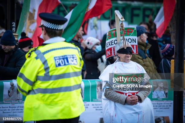 Protestor with a hangman's noose and blindfold voices her opinion, "Stop Execution in Iran" during the Support Iran's Revolution! Protest. Protestors...