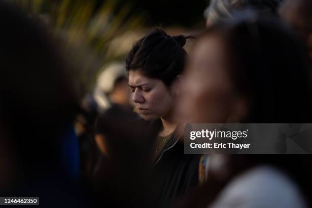 Members of the community hold a prayer vigil at Monterey Park City Hall for victims of a deadly shooting on January 22, 2023 in Monterey Park,...