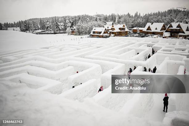 People are seen in Snowlandia Winter Theme Park's labyrinth as they try to find the way out in Zakopane, Poland on January 21, 2023. Established...