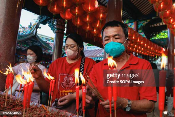 Thai-Chinese seen praying at Tai Hong Kong shrine. Lunar New Year begins on January 22, and welcomes the year of the Rabbit, celebrated by the...