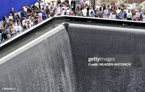 Relatives of 9/11 attack victims gather next to the 9/11 memorial pool September 11, 2011 during ceremonies marking the 10th anniversary of the World...