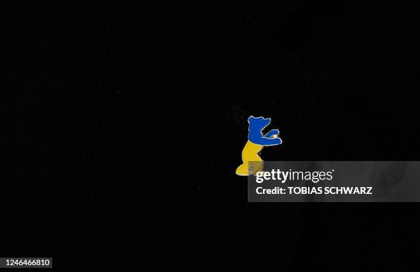 Berlinale pin in the colors of Ukraine's national flag is pictured during the the Programme Press Conference for the 73rd Berlinale Berlin Film...