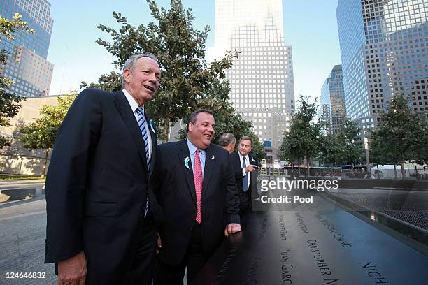 George Pataki, former New York governor and New Jersey Governor Chris Christie look out at the North Pool of the 9/11 Memorial during the tenth...
