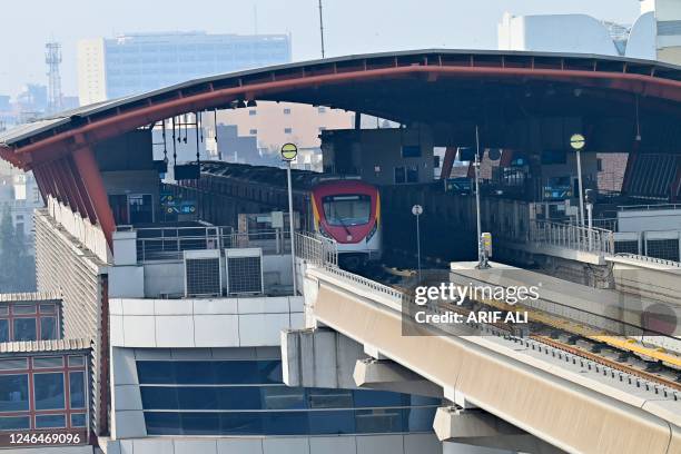 An orange line metro train stands parked at a station after train services got suspended due to a countrywide power outage in Lahore on January 23,...