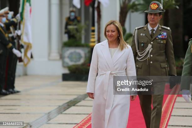 Italian Prime Minister Giorgia Meloni walks past honor guards during a welcoming ceremony by Algerian President Abdelmadjid Tebboune at El Mouradia...