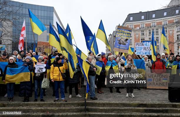 Protester hold Ukrainian flags during a demonstration in support of Ukraine, during a Foreign Affairs Council meeting at the EU headquarters in...