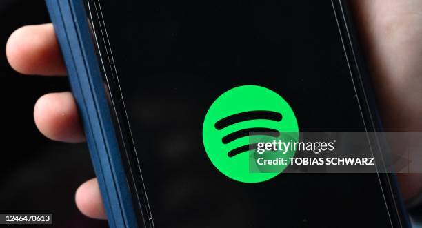 The company logo of Swedish music streaming giant spotify is pictured on a smartphone in Berlin on January 23, 2023. - Swedish music streaming giant...