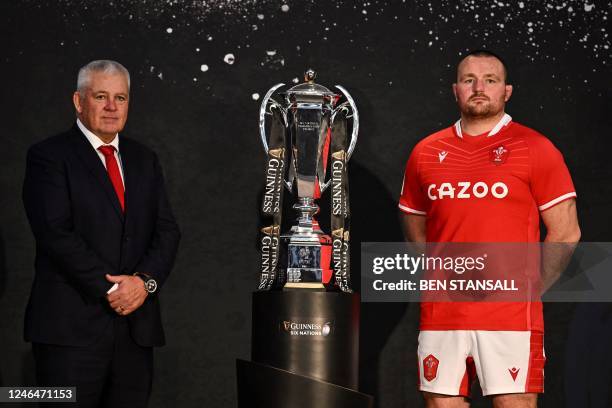 Wales' head coach Warren Gatland and Wales' captain Ken Owens pose with the Six Nations trophy during the 6 Nations Rugby Union tournament media...