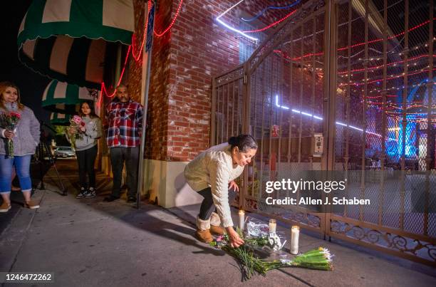 Monterey Park, CA After police tape was taken down, people line up to place flowers at the entrance to the Star Dance Studio Ballroom where Huu Can...