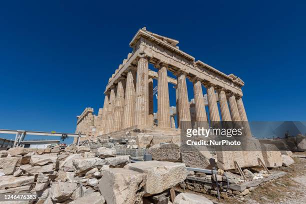 Wide angle view of the Parthenon in the Acropolis of Athens. Crowds of tourists and local visitors in front of the Parthenon, an ancient temple...