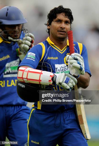 Kumar Sangakkara of Sri Lanka leaves the field with not-out batsman Suranga Lakmal after being dismissed for 75 runs in a team total of 174 in the...