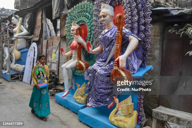 Little child is seen taking home an idol of Goddess Saraswati , ahead of Saraswati puja or Vasant Panchami celebration in Kolkata , India , on 23...