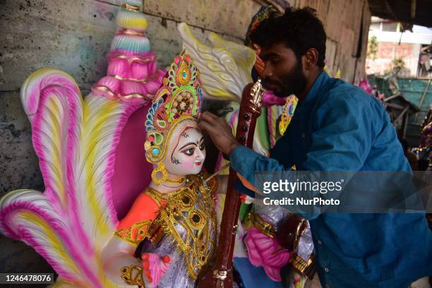 An artist is seen giving final touches to an idol of goddess Saraswati ahead of the Vasant Panchami celebration in Nagaon District of Assam , India...
