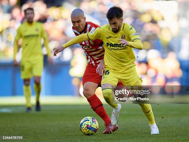 Alex Baena of Villarreal CF competes for the ball with Oriol Romeu of Girona FC during the LaLiga Santander match between Villarreal CF and Girona FC...