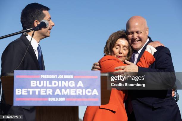 Representative Nancy Pelosi, a Democrat from California, hugs Mitch Landrieu, White House infrastructure implementation coordinator, right, during a...