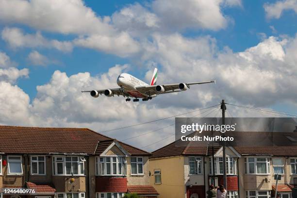 Emirates Airbus A380 aircraft as seen flying on final approach during a blue sky summer sunny day with some clouds, arriving from Dubai DXB UAE,...